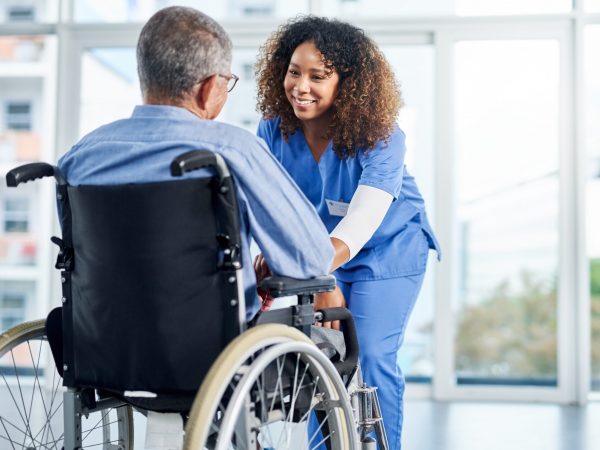 Time for us to go get some sunshine Shot of a young female nurse assisting a senior man in a wheelchair at a nursing home